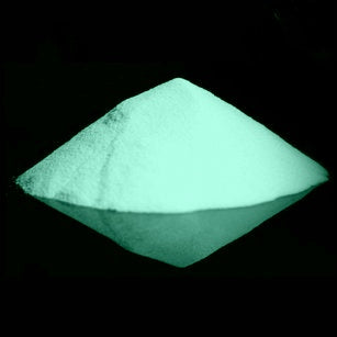 Nighttime view of glow-in-the-dark powder, brightly illuminated in a soft blue-green hue.