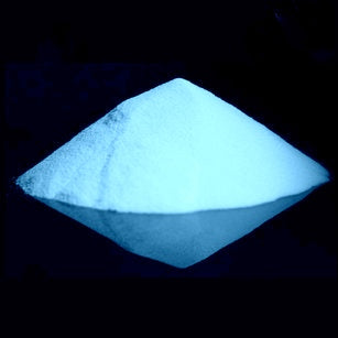 Nighttime view of glow-in-the-dark powder, brightly illuminated in a soft blue hue.